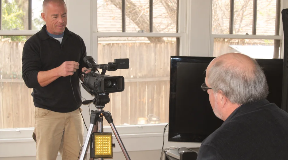 Phillip LeConte and newscaster Jim McNab tape a segment of the Police Chaplain Project