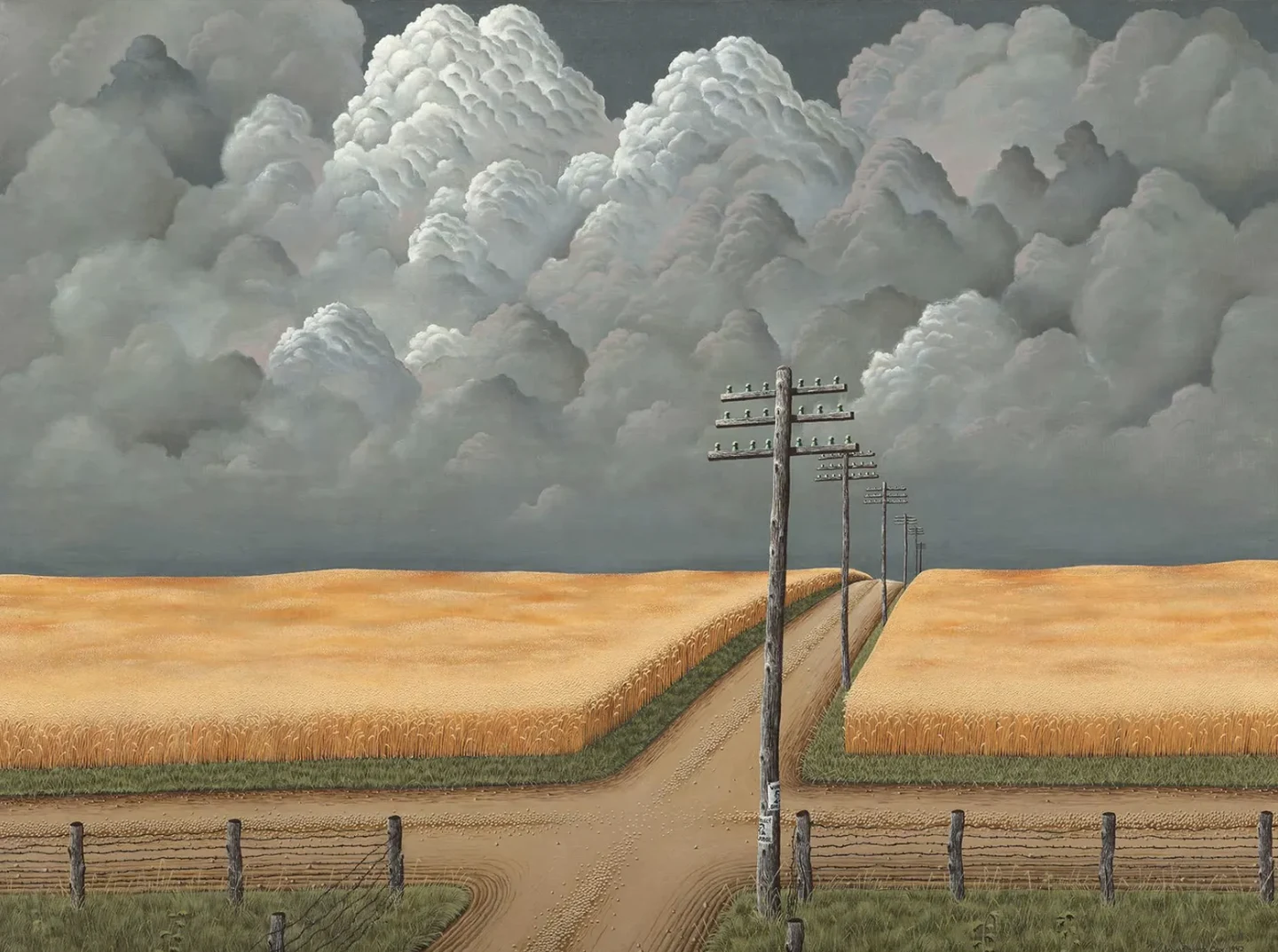 Storm clouds over golden fields and a country road.